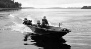 Vanerisella syöksyveneellä m/55 harjoitellaan 1960-luvulla. Moottoreina veneessä ovat pystyakseliset 40 hv:n Mercury-perämoottorit. Kevyellä singolla (55 S 55) tähtäävälle varusmiehelle on rakennettu laudasta ampumateline.